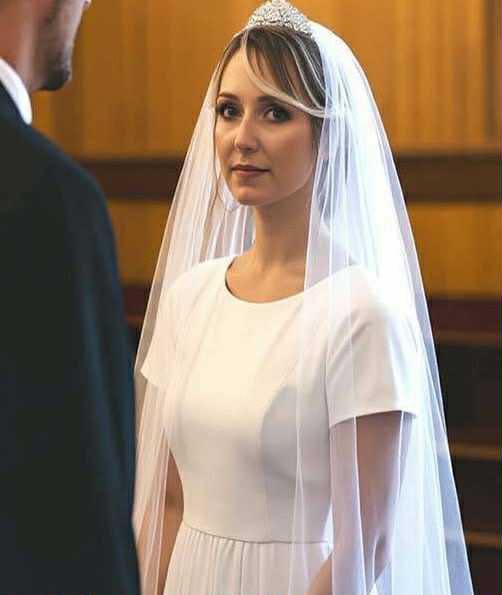 Five Years After Losing My Wife, I Took My Daughter to My Best Friend’s Wedding — Then She Asked, “Daddy, Why Are You Crying?” === Five years after losing my wife, I had convinced myself that the worst was behind me. Grief had softened from a sharp, relentless ache into something quieter, a dull hum that lingered beneath the surface of everyday life. I’d learned to live with it. Or so I thought. My daughter, Lily, is seven now. She had her mother’s eyes, gray-blue and startlingly bright, and the same way of tilting her head when she was curious about something. Sometimes, when she laughed, it caught me so off guard that I had to leave the room. Grief has a cruel sense of timing; it likes to show up in the middle of joy. That morning, she sat on the edge of my bed, legs swinging, holding the invitation that had arrived weeks earlier. “Daddy,” she said, “are we really going to Uncle Ben’s wedding?” “Yeah, sweetheart,” I said, buttoning my shirt. “We are.” Ben and I had been best friends since college, roommates, business partners, brothers in everything but blood. He’d been there for me when I lost Sarah, showing up with groceries, sitting through endless silences, taking Lily out for ice cream when I couldn’t get out of bed. When he told me he’d finally found someone, I’d been genuinely happy for him. But the invitation had come with a strange twinge I couldn’t quite place. Something in the neat handwriting on the envelope, the way my name was written “Michael and Lily,” made me pause. I brushed it off. Weddings were emotional, that’s all. The ceremony was held at an old vineyard just outside town, a place Ben had always loved. Rows of oak trees lined the path, the late afternoon light spilling golden across the grass. It was beautiful, too beautiful, in that fragile way that made my chest tighten. Lily tugged on my sleeve as we walked toward the main hall. “Do you think she’ll wear a long veil like Mommy did?” I smiled faintly. “Maybe. We’ll find out soon.” We found our seats near the front. Ben stood at the altar, straight-backed but visibly nervous, his tie slightly crooked. I almost called him out on it, like I would have years ago, but something in his expression stopped me. He wasn’t just nervous. He looked… conflicted. Then the music began. Everyone stood as the bride appeared at the far end of the aisle, her face veiled in soft lace, her dress simple and elegant. She moved slowly, gracefully, her arm looped through an older man’s. I couldn’t see her face, but something about her height, her build, the way she held herself felt disturbingly familiar. My pulse quickened. I told myself I was imagining it, that grief had a way of playing cruel tricks. When she reached the altar, Ben took her hand, and for a brief moment, he looked out over the crowd right at me. His eyes flickered with something unreadable. Then the officiant began to speak. It wasn’t until the words “You may lift the veil” that everything inside me stopped. Ben raised the lace carefully, and in that instant, the world tilted. The woman standing there was Sarah. Or no, not Sarah. But she could have been. Her face, her eyes, her soft, trembling smile, every detail matched the woman I’d buried five years earlier. My breath caught in my throat. The room blurred around me. “Daddy,” Lily whispered beside me, her small hand slipping into mine. “Why are you crying?” I hadn’t realized I was. Tears burned my cheeks as the bride’s eyes found mine over Ben’s shoulder. She froze. Her lips parted in shock, her skin paling beneath the warm light. It was as if the world had fallen silent. Ben noticed. His gaze followed hers and landed on me, and in that split second, something passed between us. A truth I wasn’t ready to face. The ceremony stumbled on, the officiant’s voice distant, muffled. I didn’t hear the vows. I didn’t see the smiles or the applause. I just sat there, staring at the impossible reflection of my dead wife standing beside my best friend. Afterward, as guests filed toward the reception area, I stood on shaky legs. Lily tugged on my hand again. “Daddy, that lady looks like Mommy,” she said matter-of-factly. “But Mommy’s in heaven.” I swallowed hard. “I know, sweetheart. I know.” Ben approached me, his face drawn tight. “Mike,” he said quietly, “can we talk?” I nodded numbly, and he led me away from the crowd, behind the vineyard’s storage barn, where the air smelled of earth and grapes. “I was going to tell you,” he began, voice low and tense. “Tell me what?” I snapped. “That you married my wife’s double? That she looks like Sarah because—because what, Ben?” He ran a hand through his hair. “Because… (continue reading in the 1st comment